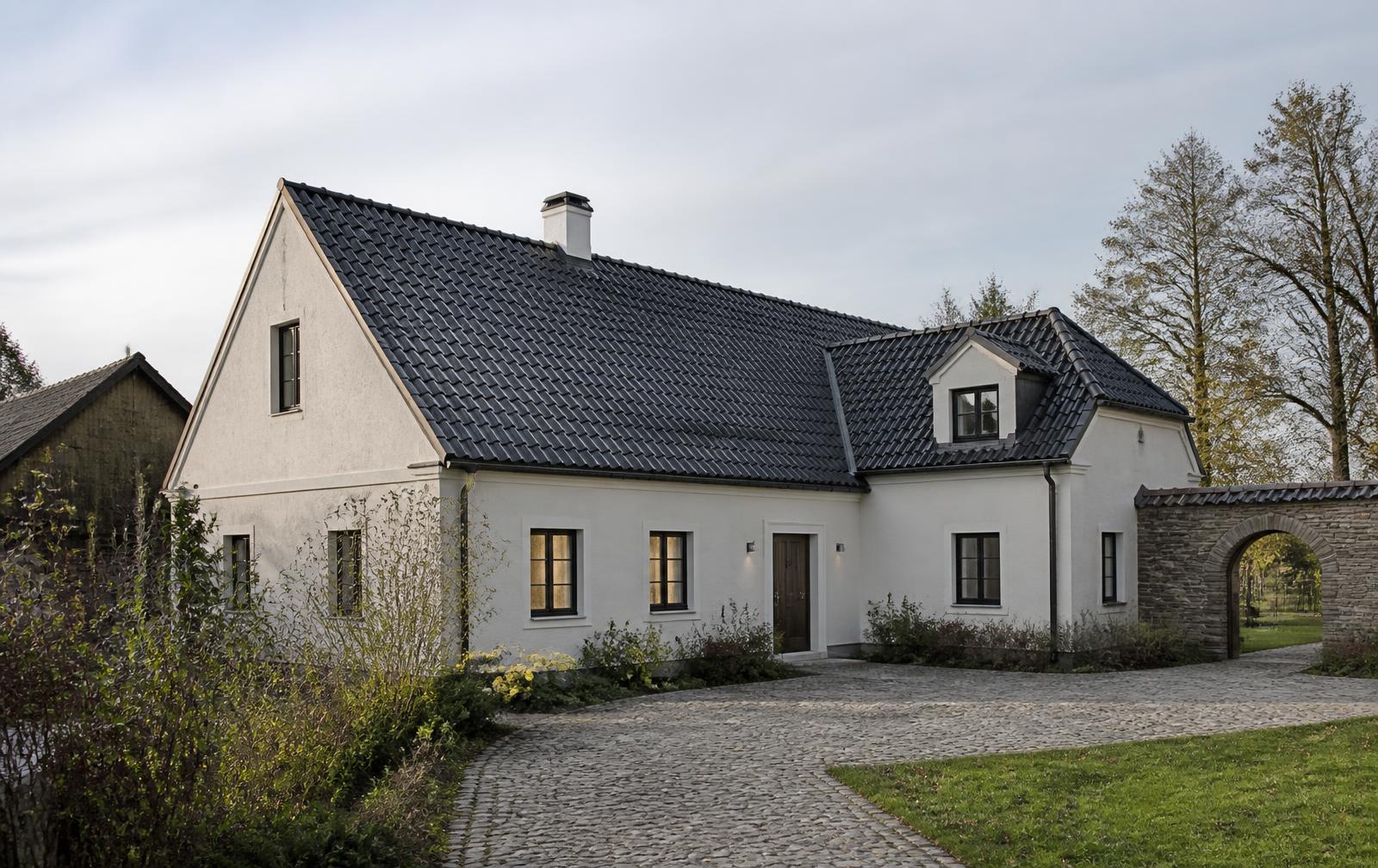 Saniertes Wohnhaus mit neuer dunkler Ziegeldeckung und präzisem Ortgang